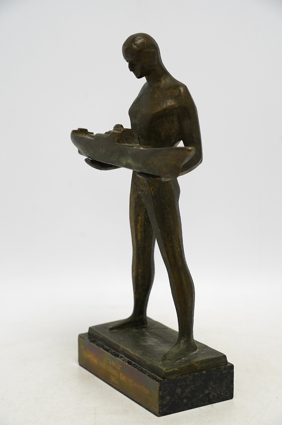 A 1960s modernist bronze figure of a man holding a boat, plaque inscribed ‘“3.MAJ” SHIPYARD AND DIESEL ENGINE FACTORY 1968.’, 29cm. Condition - fair to good